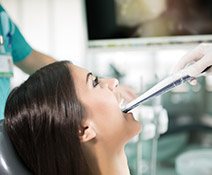 Woman in dental chair receiving intraoral photos