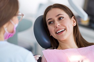 Young woman smiling in dental exam chair