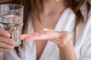 Lady prepares to take pill