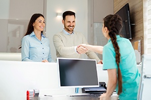 Man shaking a receptionist’s hand