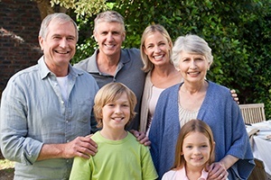 Three generations of family smiling together outdoors