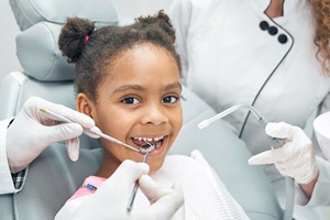 A young girl having her teeth checked and cleaned during a regular dental appointment