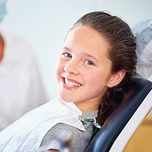 Smiling young girl in dental chair