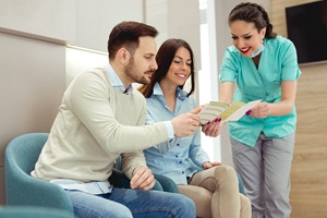 Young couple learning about payment options for dental implants