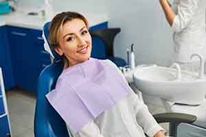 Woman smiling while sitting in treatment chair
