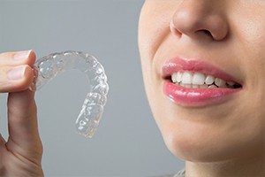 Closeup of patient holding Invisalign tray