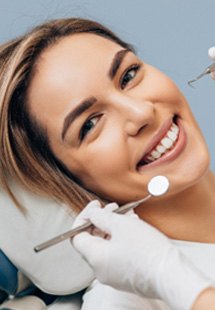 Woman smiling during dental checkup with Lakewood dentist