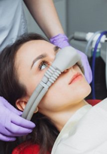 Woman relaxing while getting sedation dentistry near Lakewood
