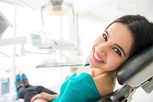 Smiling young woman in dental chair