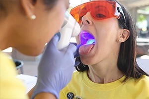 Woman receiving oral cancer screening