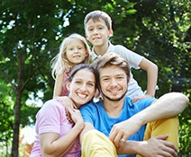 Smiling mother father and two children outdoors