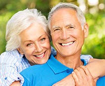 Smiling older man and woman outdoors