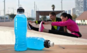 people stretching with sports drinks