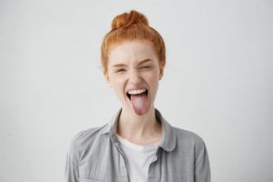 person sticking out their tongue and smiling