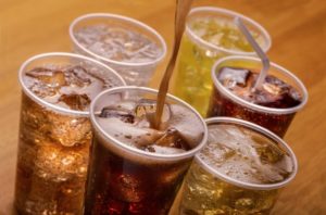 carbonated beverages in clear plastic cups 