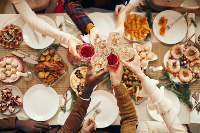 People raising glasses over a festive holiday dinner