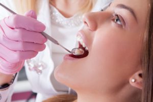 A woman having a dental examination.  