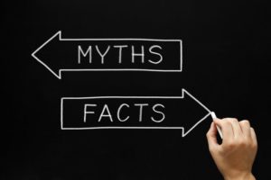 a person drawing two arrows, one that says "myths" and one that says "facts"