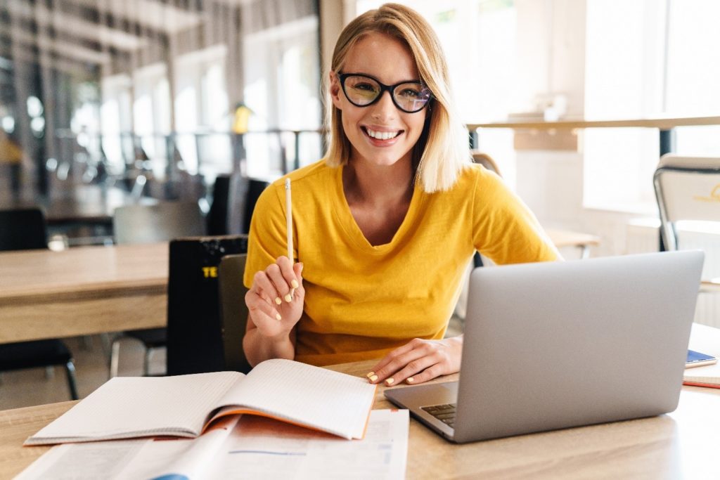 Smiling woman researching how to prepare for Invisalign