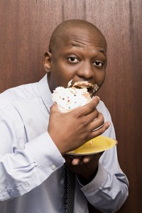 Man eating cake with food on mouth didn't get the facts on food and teeth from the dentist office lakewood dallas prefers